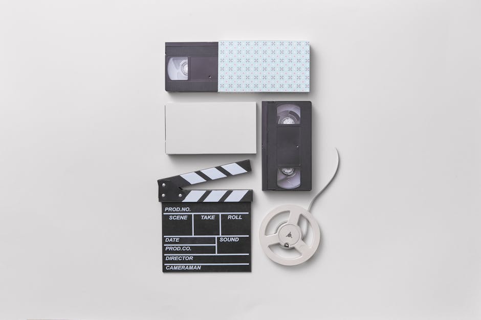 Vintage media setup featuring VHS tapes and a film clapperboard for a nostalgic cinematic feel.